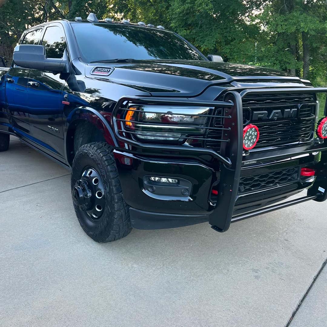 Illuminate the road ahead with style! 🚘✨ Our Grille Guard and 7.0" Red Trim Rings LED Flood Lights are ready to transform your RAM 3500. #LightUpYour